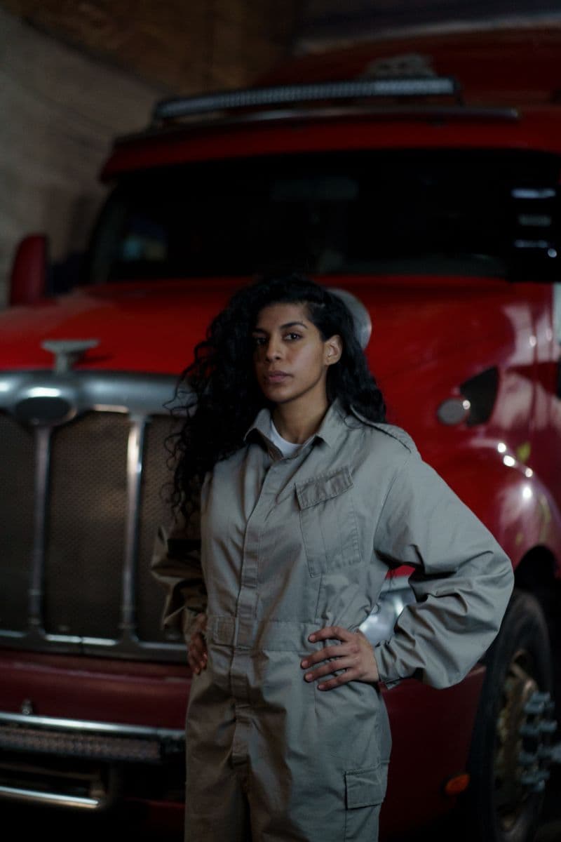 Woman owner-operator standing in front of her truck